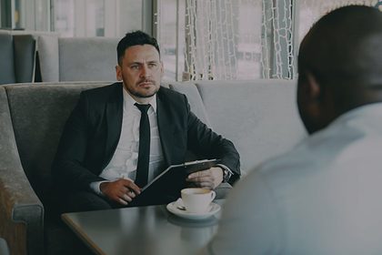 A consultant in conversation across a low table