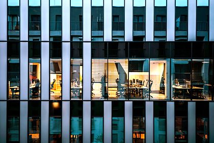 An office tower at night with lit floors